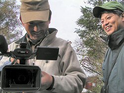 Producer and camerman in garden